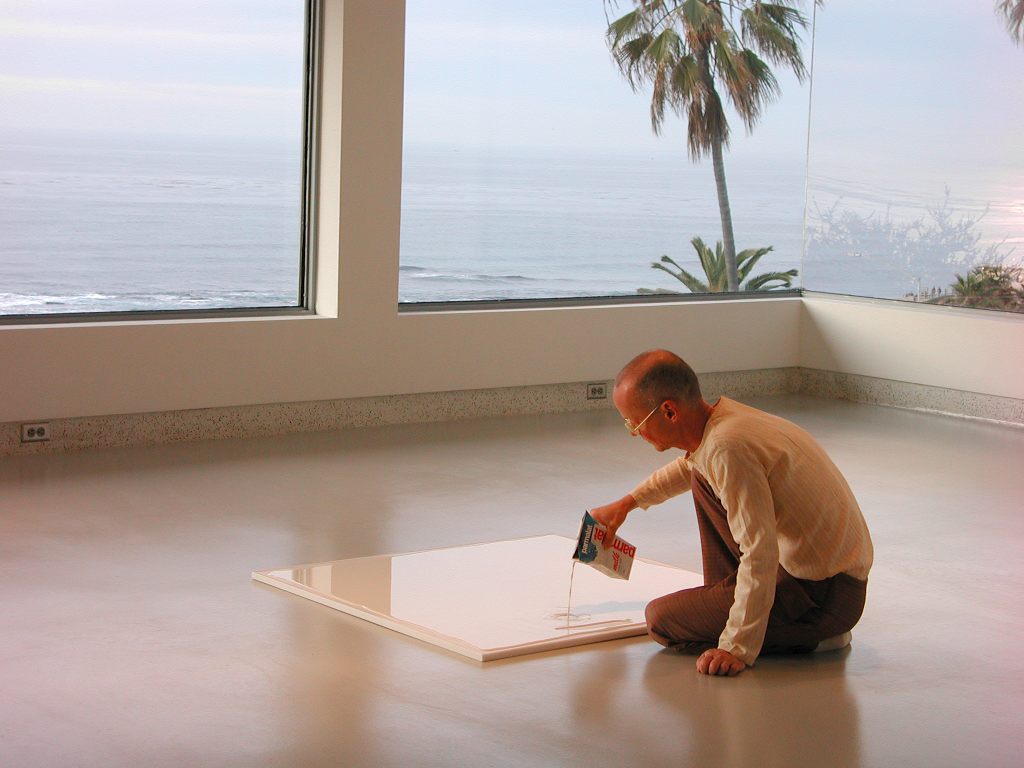 Artist pouring milk on marble